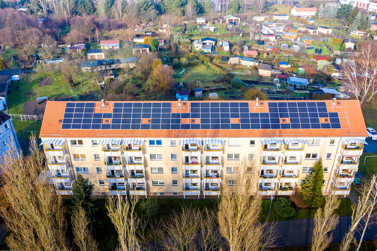 Aerial view of apartment complex with solar panels on rooftop in Beeskow, Germany.